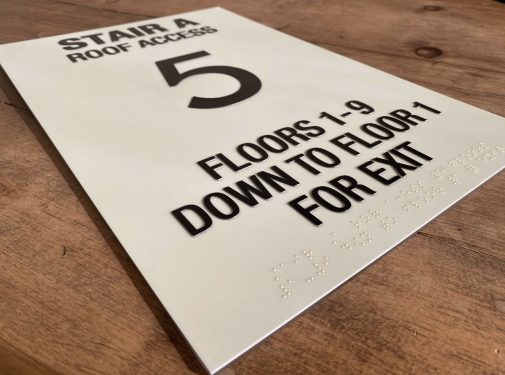 Detailed view of a photoluminescent sign ensuring visibility and accessibility during power outages. 