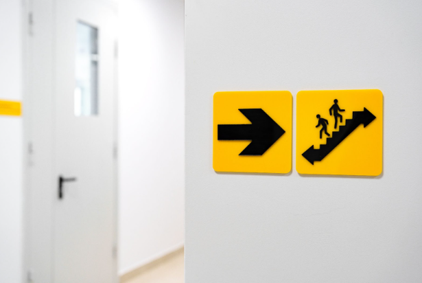 Bright, directional building wayfinding signage in a staircase.