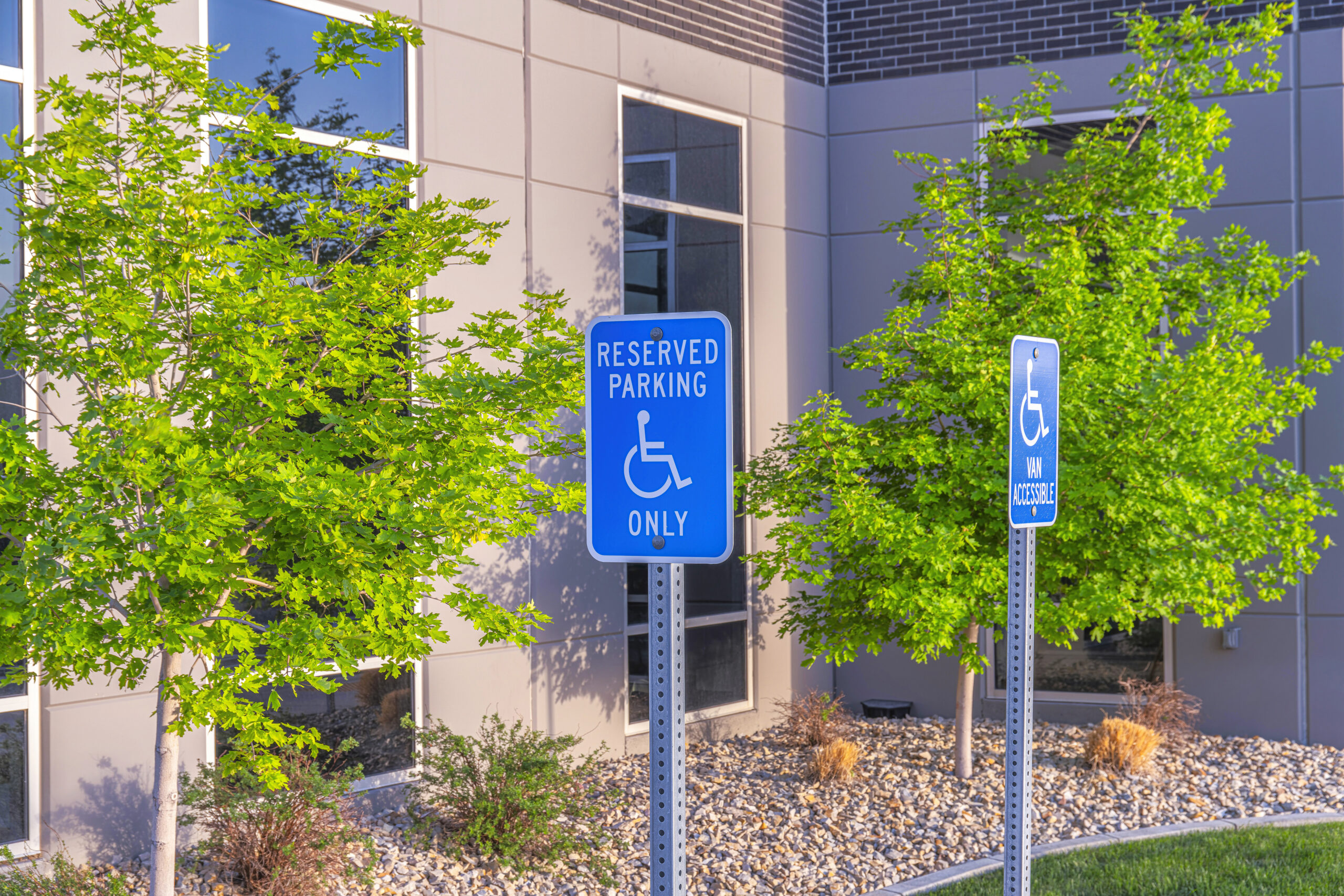 ADA parking signs in a building’s lot.
