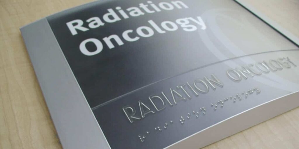 A hospital wayfinding sign displaying clear, ADA compliant fonts with large uppercase letters, ensuring easy readability for all visitors.