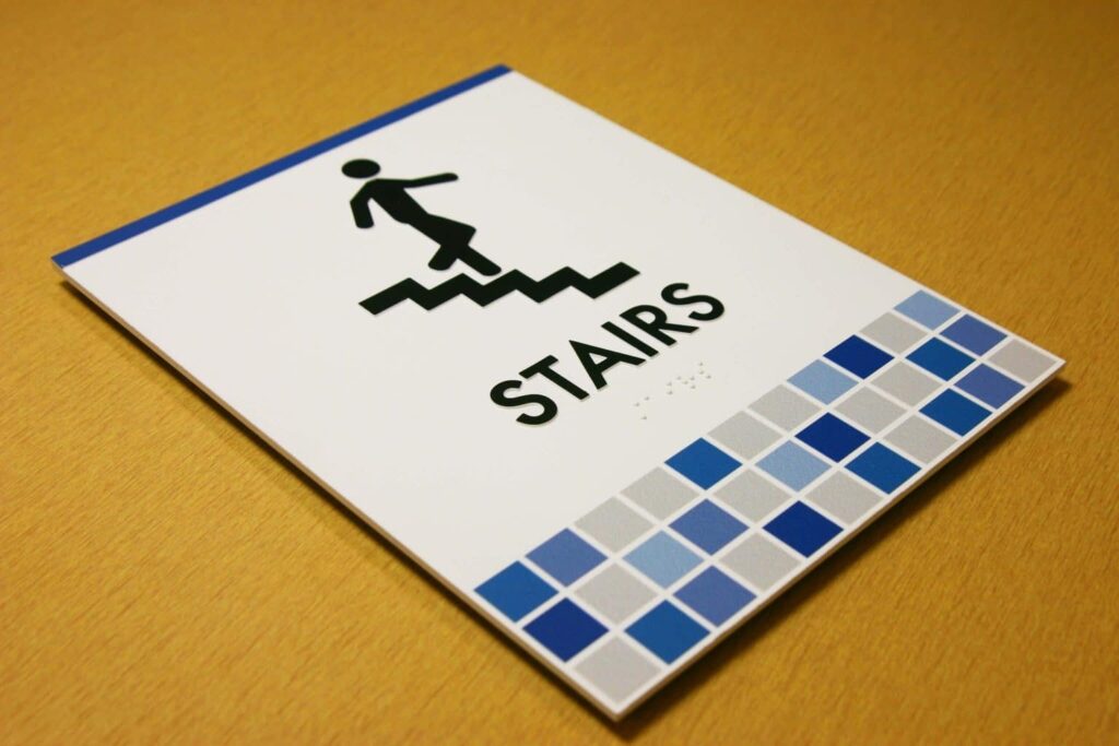ADA braille sign created with Novacryl EX Series, built for durability in exterior environments.