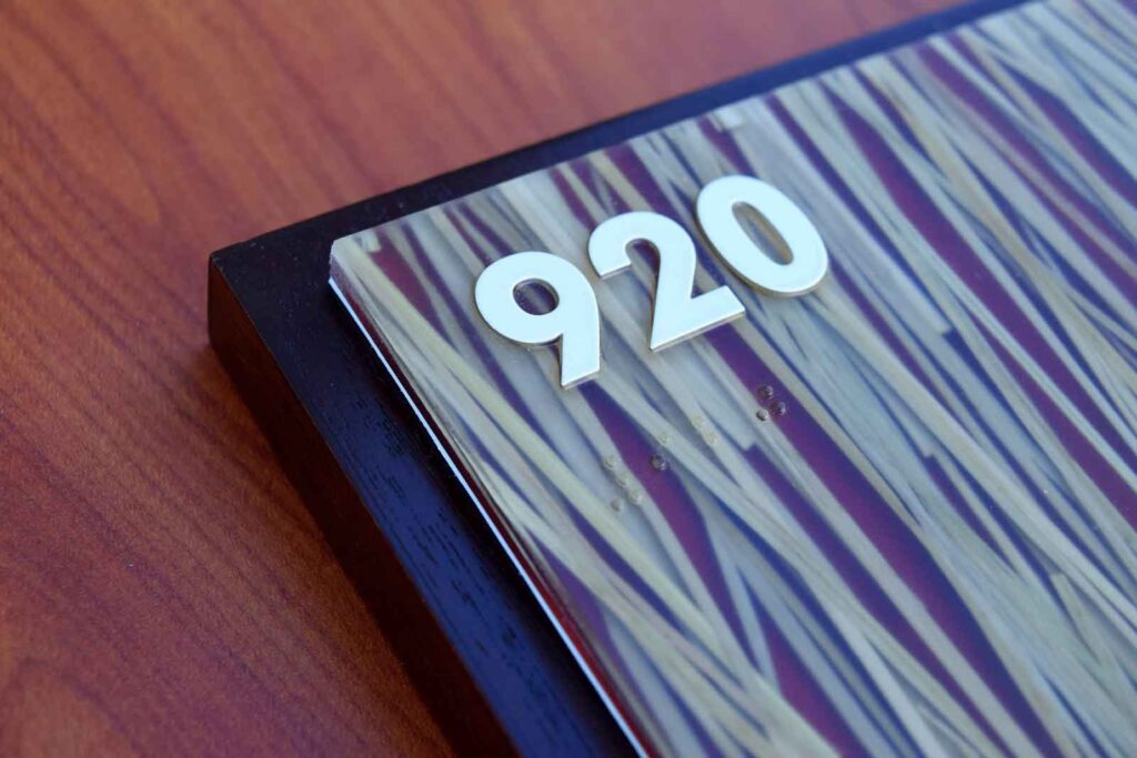 ADA braille sign designed with Novacryl ECR Series, incorporating natural patterns and eco-friendly materials.