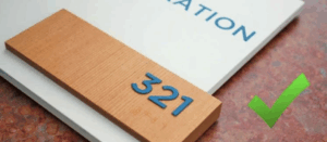 Close-up of an ADA-compliant sign showing clear and appropriate font size, highlighting the precision required by sign fabricators.