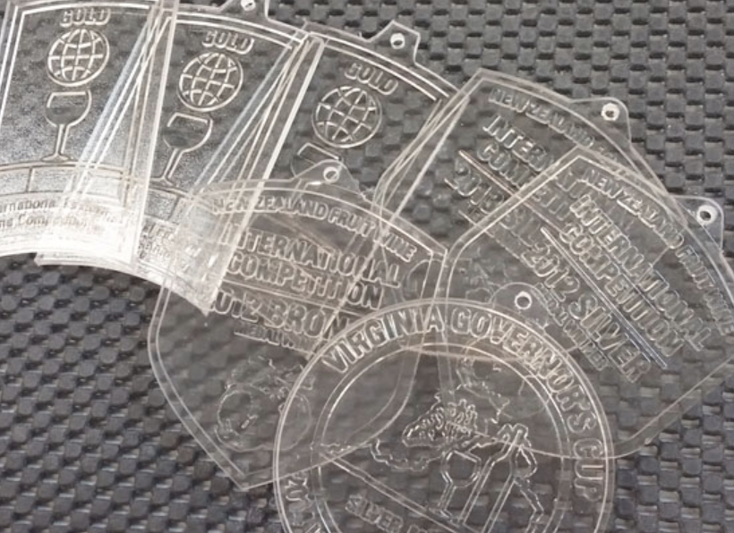 Close-up of award medals created with applications of photopolymer technology for precision detailing.