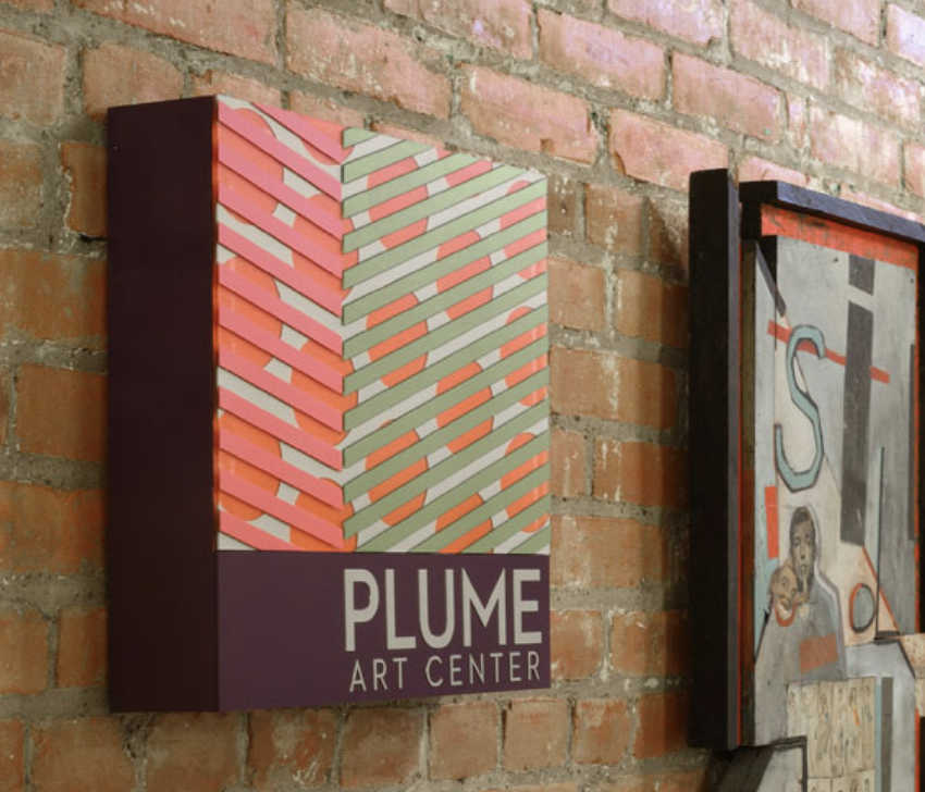 Dual-color tactile sign with a photopolymer face, featuring a painted and tipped bottom half for enhanced contrast and texture.