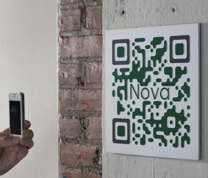 Tactile sign with a raised photopolymer QR code, enabling easy scanning and a unique tactile experience.