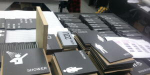 Multiple photopolymer ADA signs efficiently manufactured, highlighting the scalability of the process.