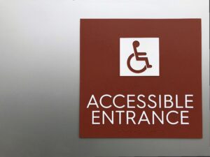 Example of braille signage requirements for ADA compliance in public spaces.
