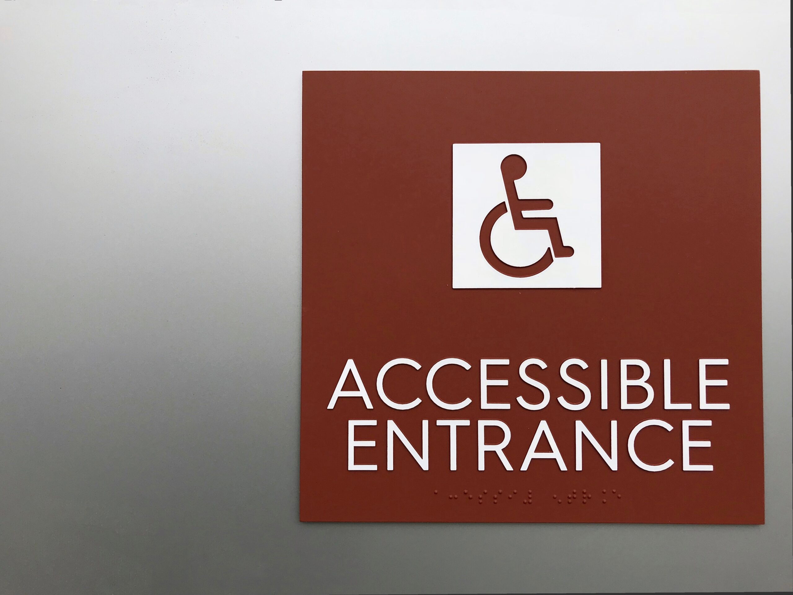 Example of braille signage requirements for ADA compliance in public spaces.